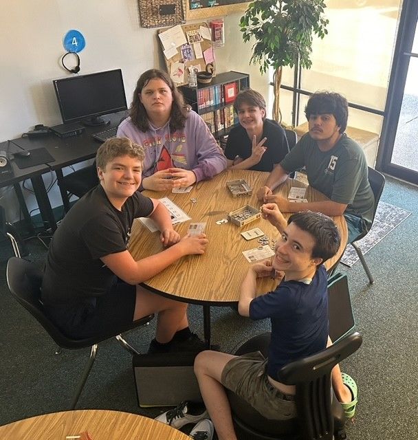 High school kids around a table smiling