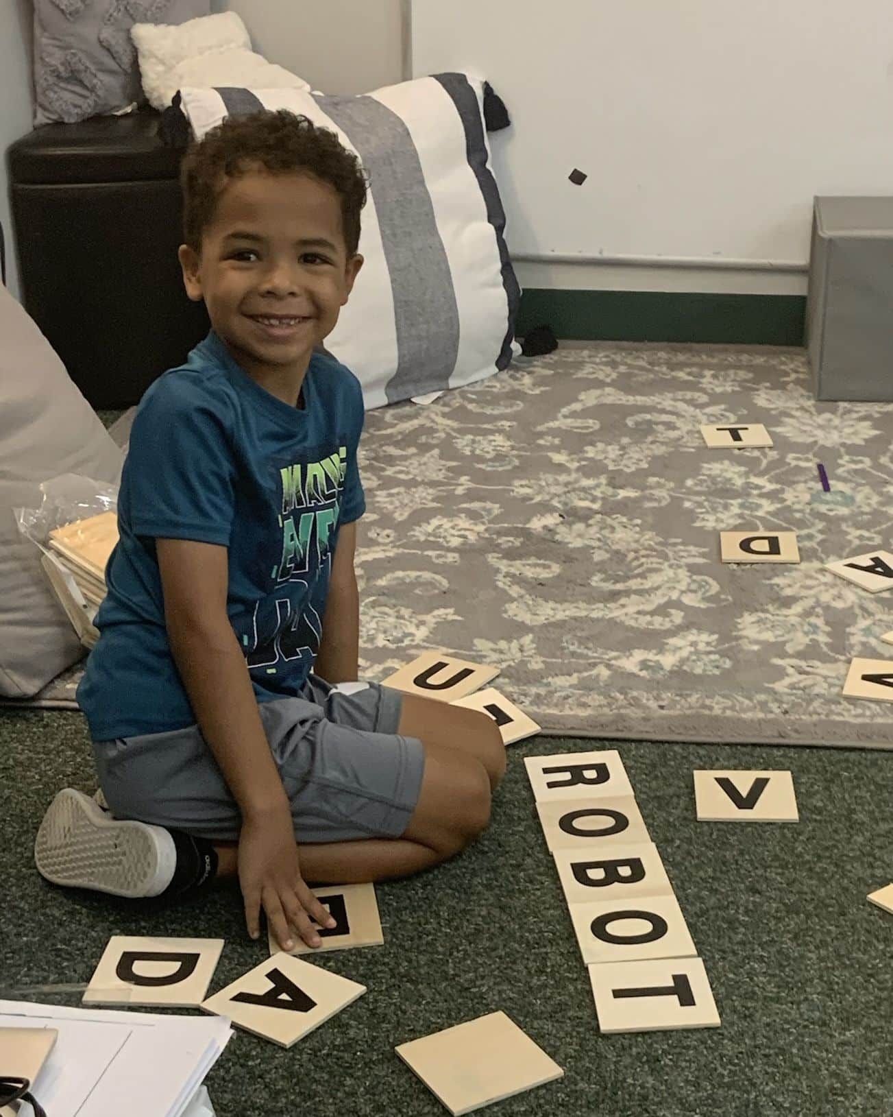 Child working on forming words with letter tiles