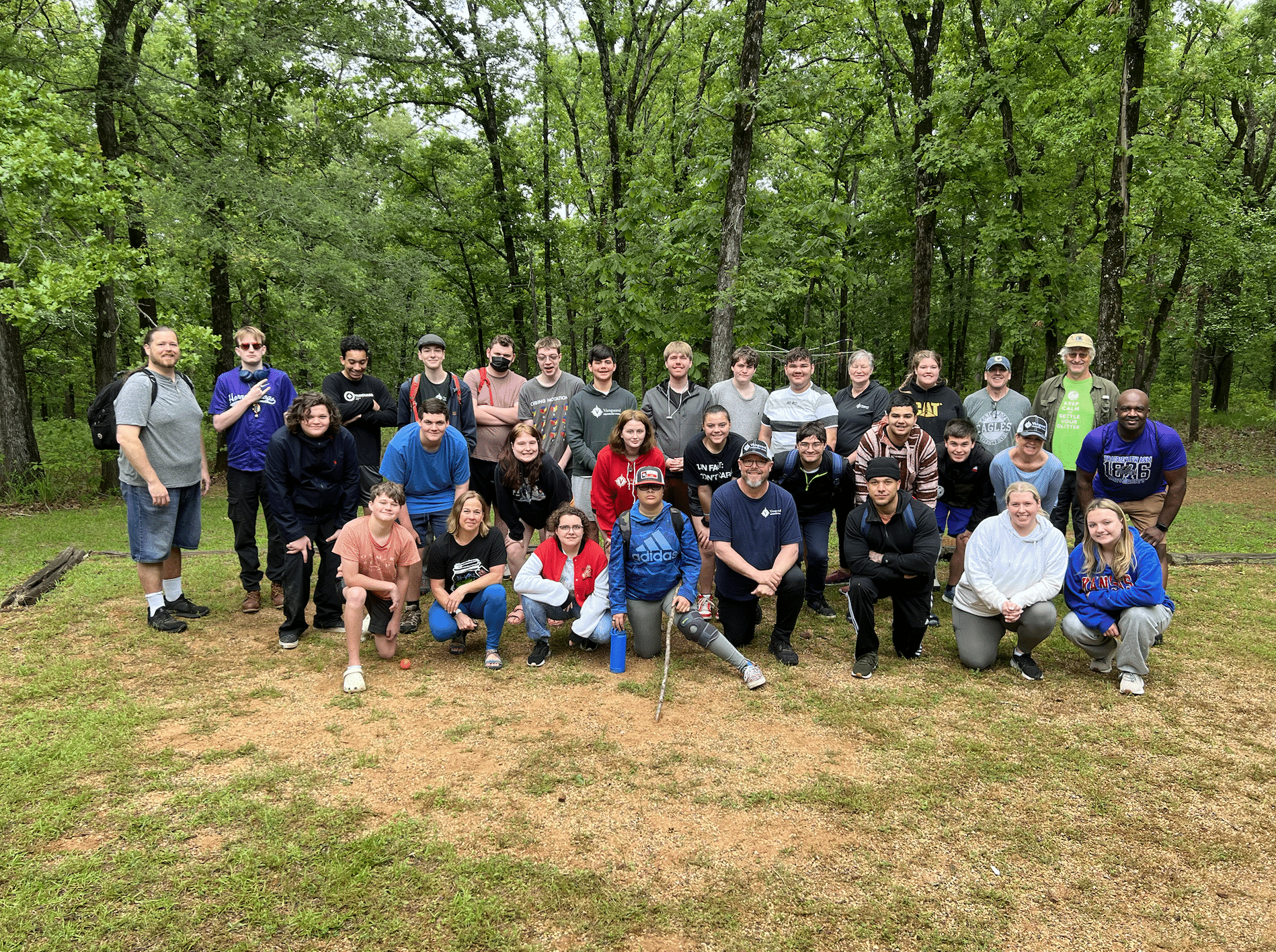 bunch of people posing in the woods