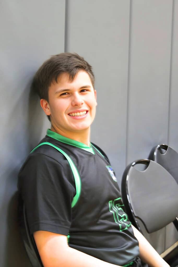 Boy from the basketball team smiling for a photo